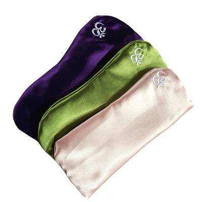 Yoga eye pillow in light pink, purple, and green imitation silk fabric.