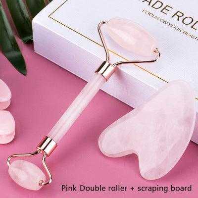 Pink gua sha stone and roller for face massage and wrinkle removal.