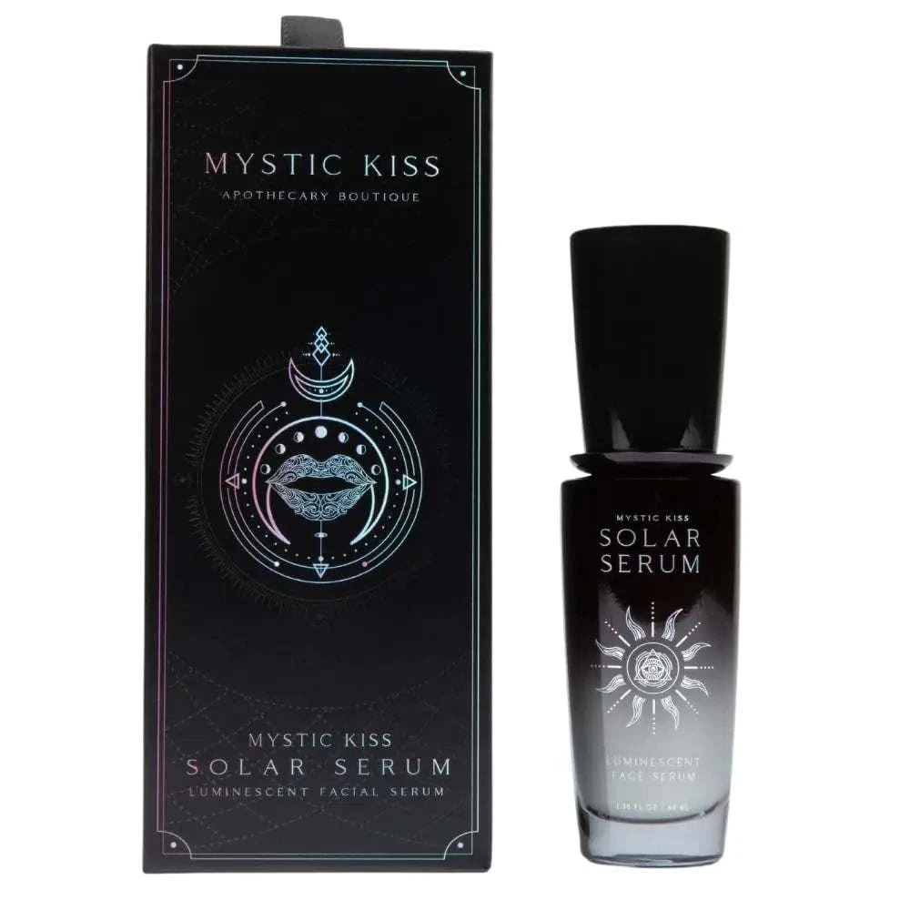 bottle and box of Mystic Kiss Solar Serum luminescent facial serum with black and silver design