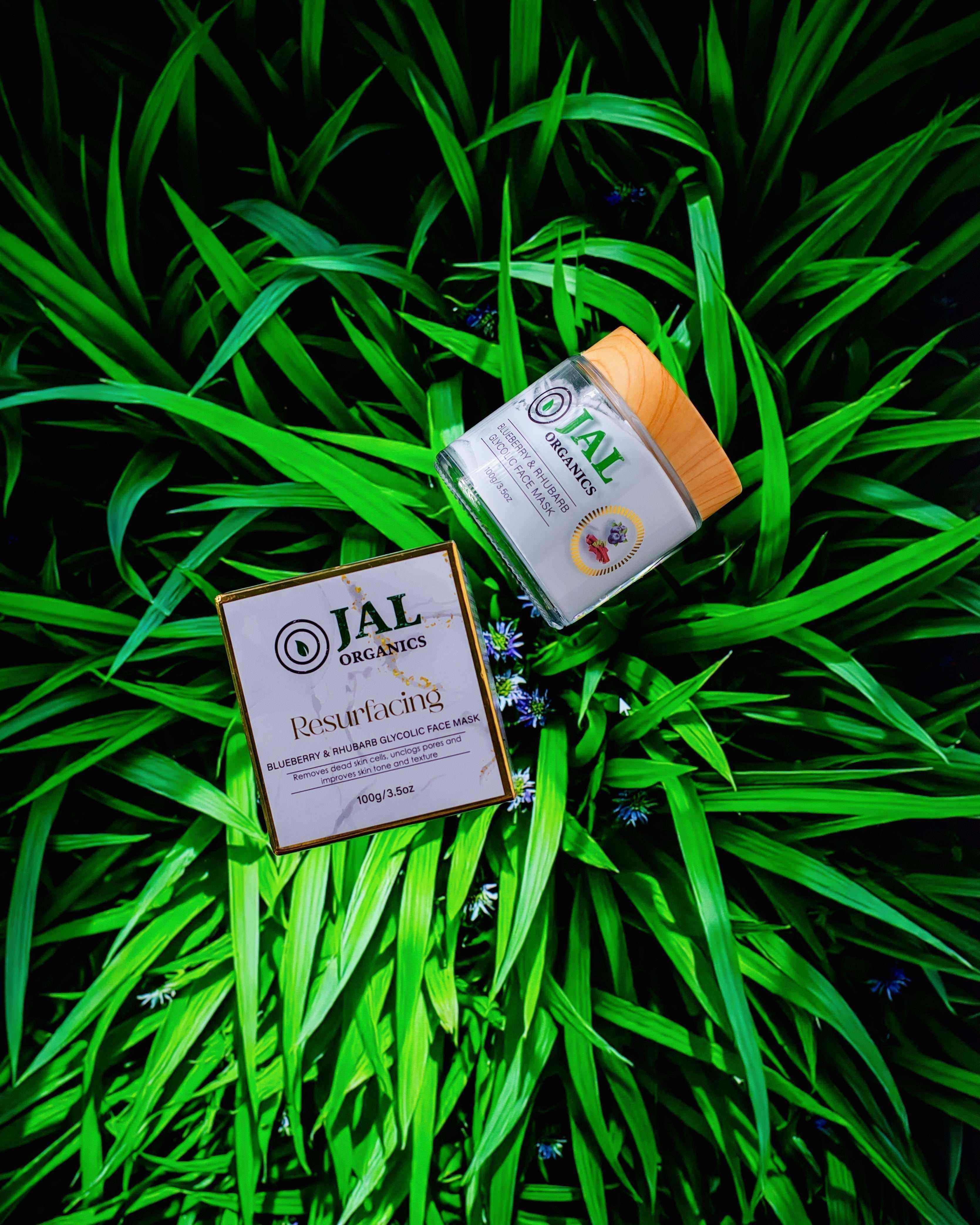 Blueberry Rhubarb Mask with Glycolic for skin exfoliation, displayed on green foliage.