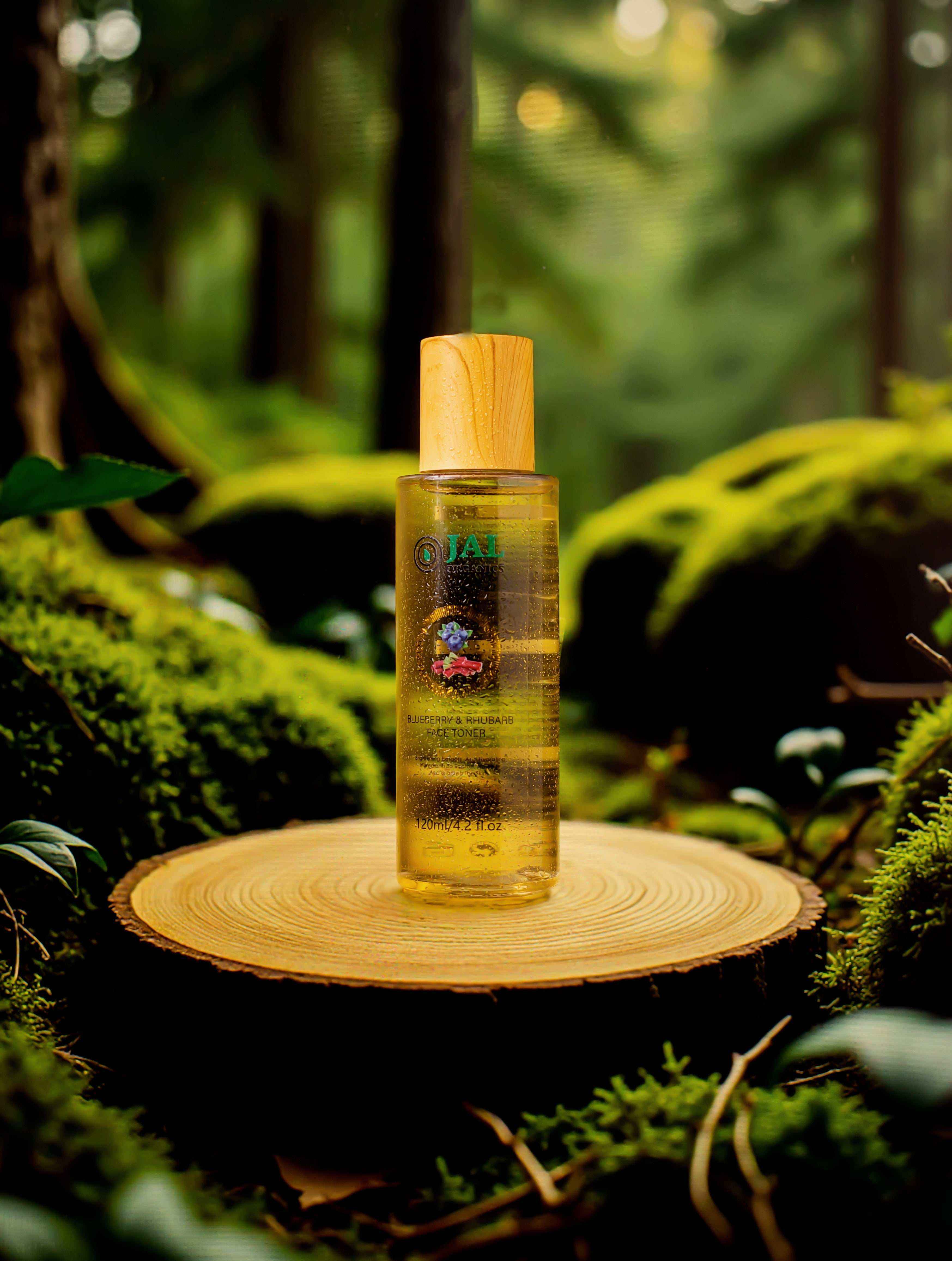 Blueberry and Rhubarb Toner bottle on a wooden platform surrounded by lush greenery.