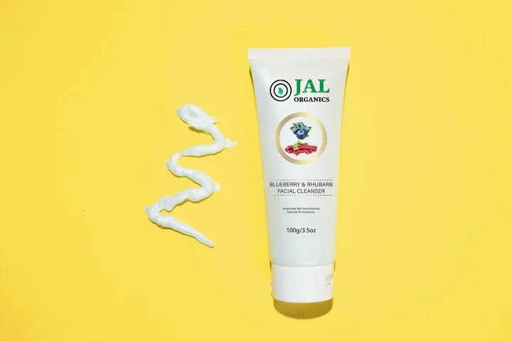 Blueberry Rhubarb Facial Cleanser from Jal Organics displayed on a yellow background with cream texture.