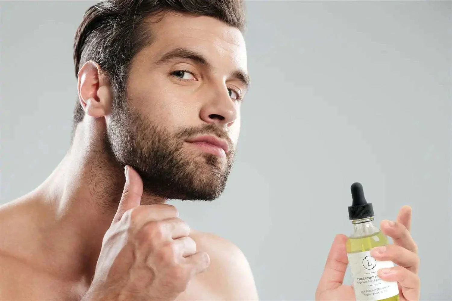 Man applying Pure Blend Beard Nourishment Oil with pipette dropper for soft, nourished beard care