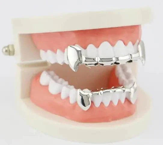 Silver bucktooth metal caps fitted on dental model teeth for hip-hop style grillz