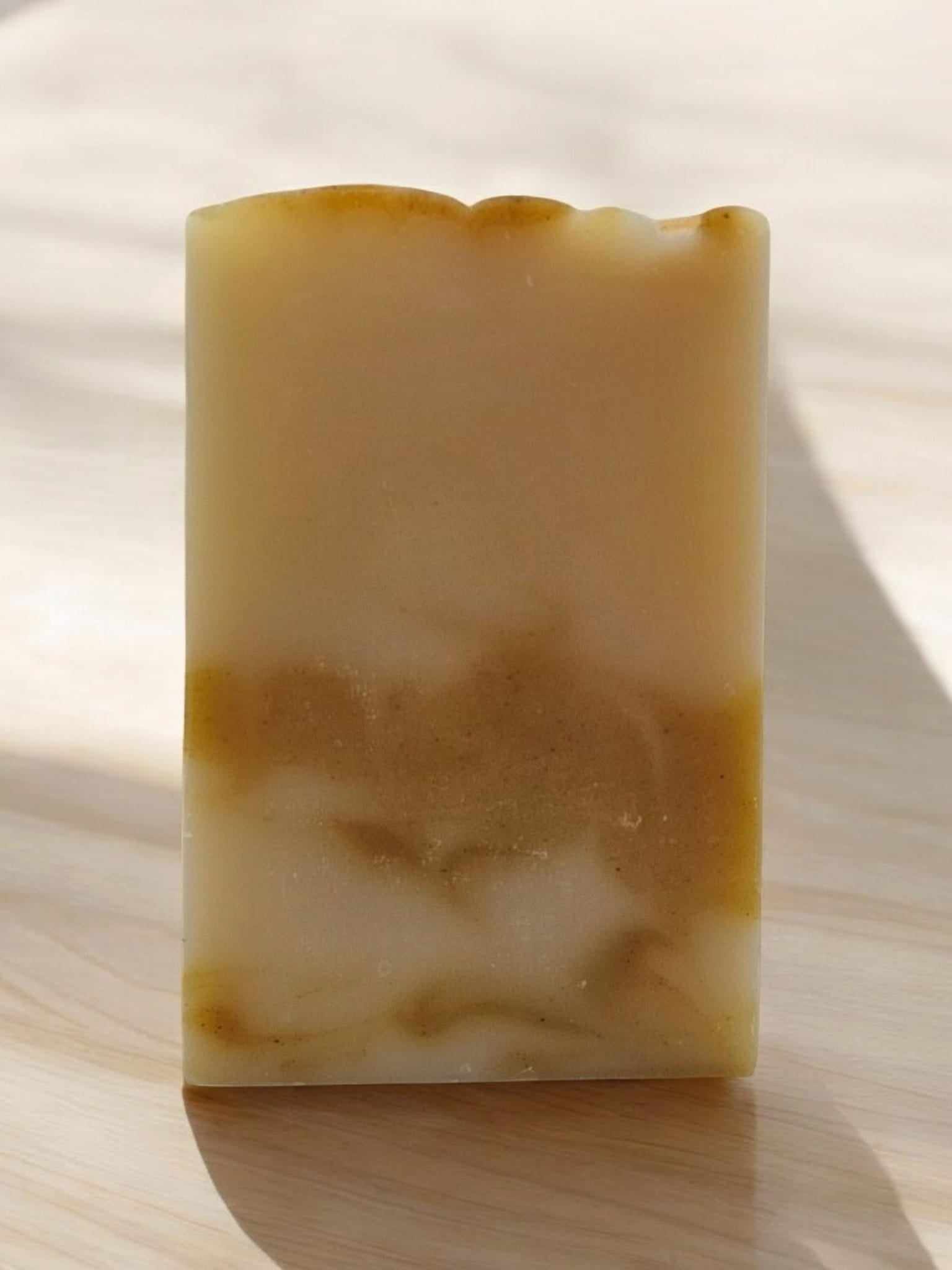 Hydrating Ginger Facial Soap with nourishing oils, depicted against a light background.