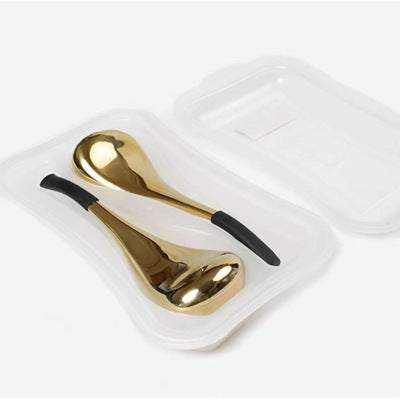 Gold finish stainless steel eye massage ice scoops in packaging; cooling therapy tool.
