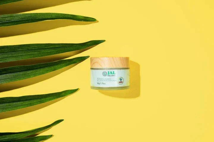 5-Piece Blueberry Rhubarb Skin Care Set jar on yellow background with green leaves.