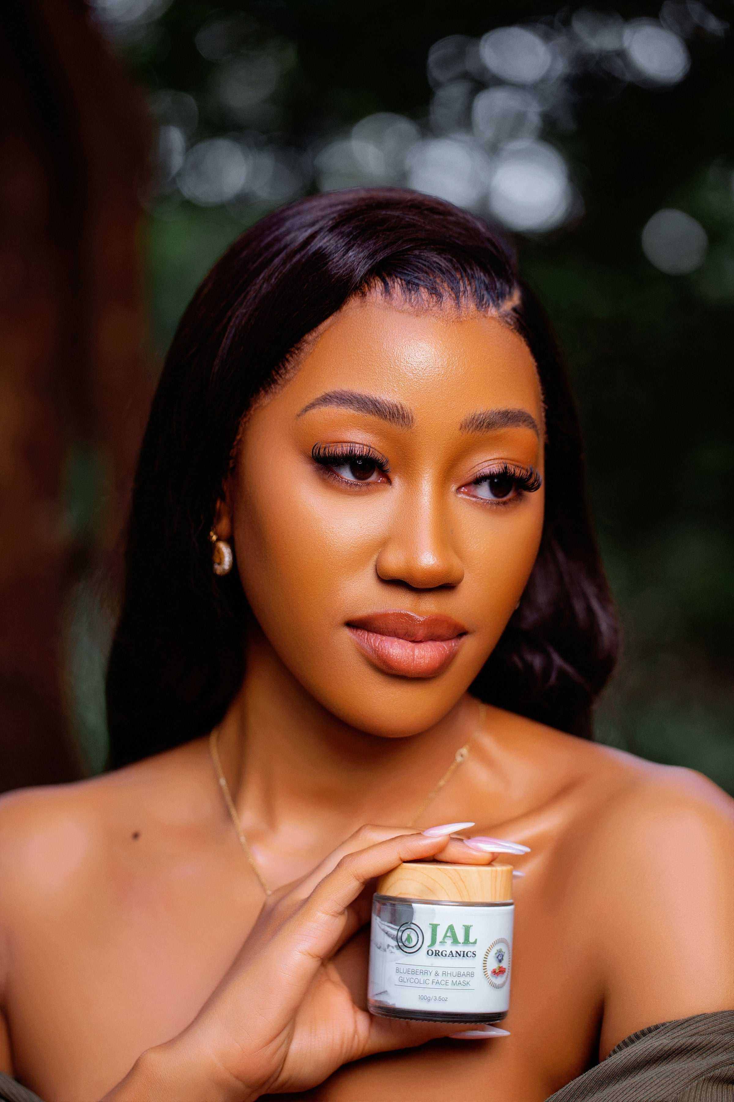 Person holding Blueberry Rhubarb Mask container in an outdoor setting.