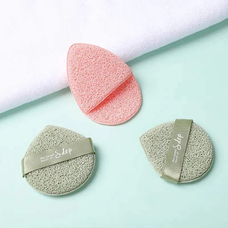 Travel-ready exfoliating face puff set in pink and gray for gentle facial cleansing and exfoliation.