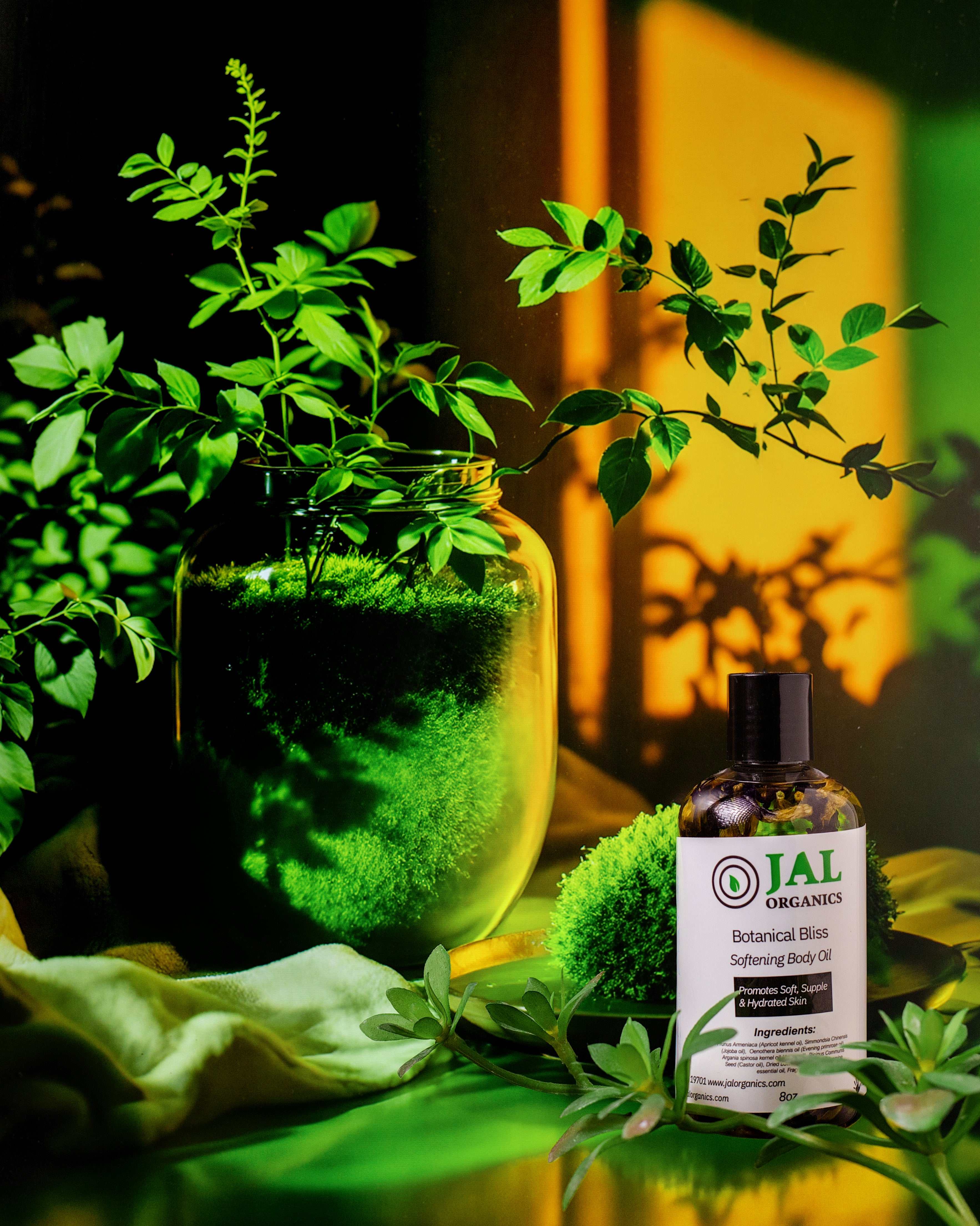 Botanical Bliss Body Oil bottle surrounded by lush greenery, highlighting its natural ingredients and hydrating benefits.