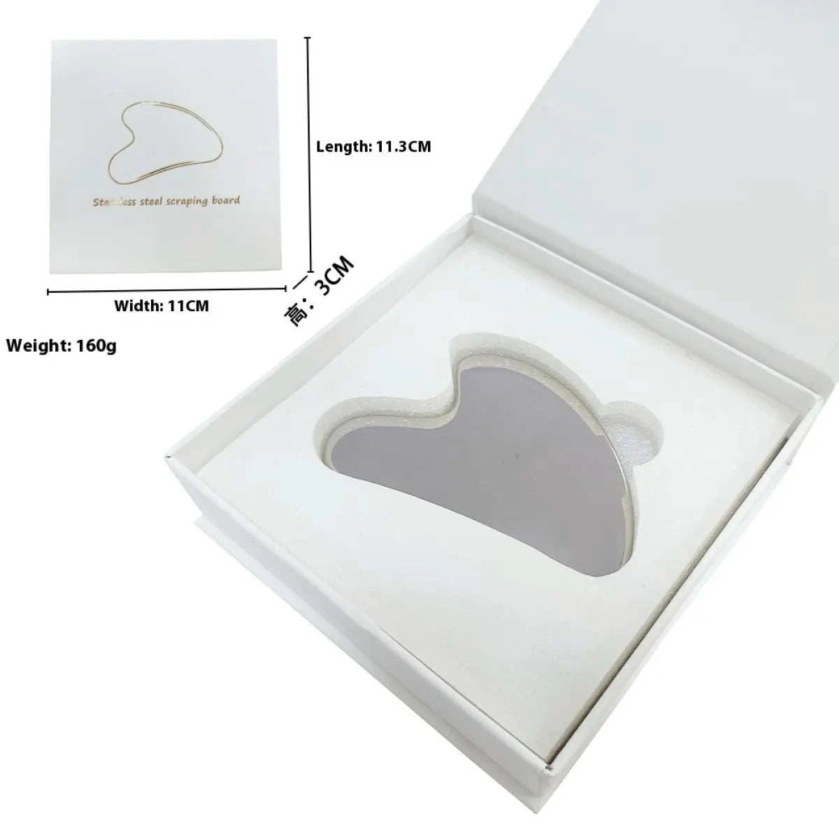 Heart-shaped stainless steel Gua Sha in packaging for skincare and massage.
